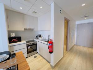 a kitchen with a fire extinguisher in the middle of it at Cosy Studio in Yas Island, Abu Dhabi in Abu Dhabi