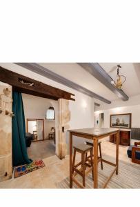 a dining room with a table and a living room at Rent big room with breakfast free in old city in Nancy