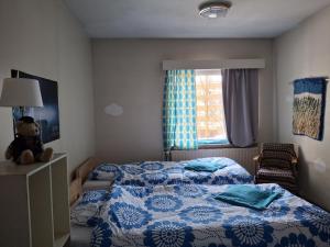 a small bedroom with a bed and a teddy bear at OuluHostel AlliMaria in Oulu