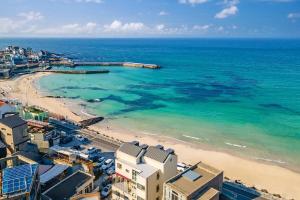 an aerial view of a beach and the ocean at Jeju Dalbeach Pension in Jeju
