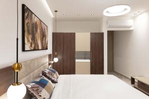 En eller flere senge i et værelse på The Grand Oasis Villa