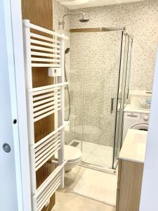 a bathroom with a toilet and a glass shower at Appartement Saint-Raphaël in Saint-Raphaël +12 photos
