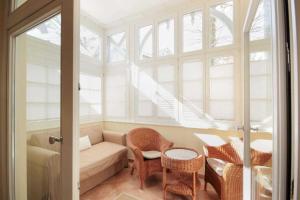 a living room with a couch and chairs and a window at Villa Malepartus by Rujana in Binz +15 photos