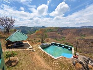 a swimming pool with a view of the mountains at Fifth Estate in Vagamon