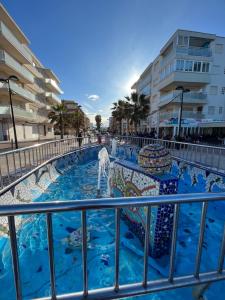 a pool with a fountain in the middle of a building at Duna Sunset - Ganador Traveller Awards 2026 in Daimuz