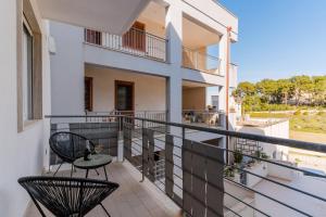 a balcony with two chairs and a table at Suite Black and White in Otranto