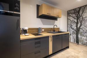 a kitchen with a sink and a counter top at Gîte l'évasion in Chaillac-sur-Vienne