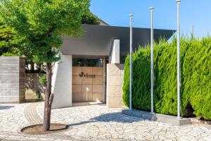 a tree in a courtyard in front of a building at WeBase KAMAKURA in Kamakura