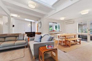 a living room with a couch and a table at Moonah Cottage Rye by Ready Set Stay - BYO LINEN & TOWELS in Rye