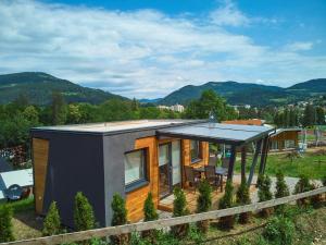 a modern house with a view of the mountains at Natura Fina Resort in Ravne na Koroškem