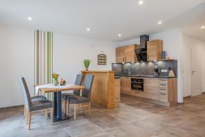 a kitchen with a wooden table and a table and chairs at Haus Sonnengruss in Salem