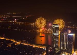 a view of a city at night with fireworks at Grand Hyatt Changsha in Changsha