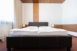 A bed or beds in a room at Hotel Slovakia