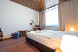 A bed or beds in a room at Hotel Slovakia
