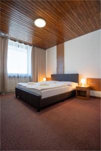 A bed or beds in a room at Hotel Slovakia