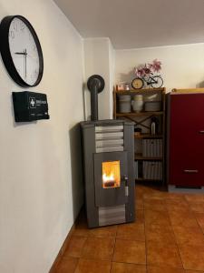 a room with a fireplace and a clock on the wall at Großzügiges Haus in Moselnähe in Neumagen-Dhron