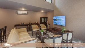 a living room with a living room with sharp inch tv at Lilly Valley Villa In Lonavala in Lonavala +11 photos