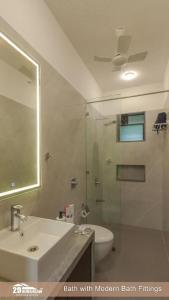 a bathroom with a sink and a toilet and a shower at Lilly Valley Villa In Lonavala in Lonavala