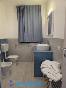 a bathroom with a sink and a toilet at Casa Bonita Pachino in Pachino