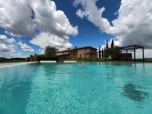 a large pool of water in front of a building at Villa il Castagno Wine & Resort in Siena