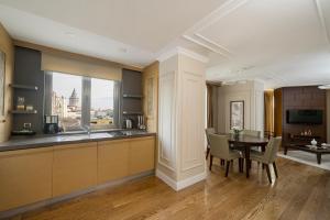 a kitchen and dining room with a table and a window at Continental Hotel Pera in Istanbul