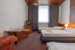 A bed or beds in a room at Hotel Slovakia
