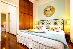 a bedroom with a large bed with a hat on it at Chanialiving Venetian Luxury House-near Plaza Parking in Chania Town