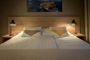 a bedroom with a large bed with two lamps at Hotel Gullfoss in Haukadalur