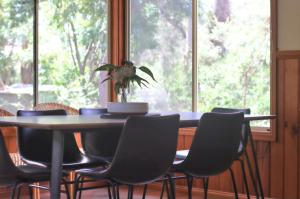 a table with chairs and a potted plant on it at Jimmara Views 3bd with Pinnacle outlook in Halls Gap