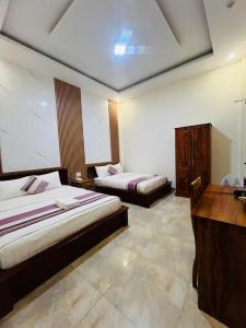 Voodi või voodid majutusasutuse Hoang Quan Hotel toas