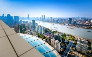 a view of a city from the top of a building at Novotel Atlantis Shanghai - Enjoy our great-valued breakfast in our rooftop revolving restaurant with a stunning river view & utilize our FREE self-serviced laundry in Shanghai