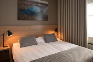 a bedroom with a bed with two pillows on it at Hotel Gullfoss in Haukadalur