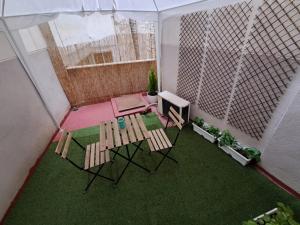a balcony with a table and chairs and a television at Apartamento San Andrés in Teruel