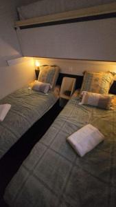 two beds sitting next to each other in a room at Le Relais de D'Artagnan in Peyrusse-Grande
