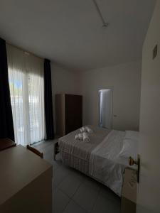 Postel nebo postele na pokoji v ubytování Hotel Bianca Orchidea