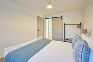 a bedroom with a large bed with a blue blanket at Host & Stay - Middle Cottage in Seahouses +18 photos