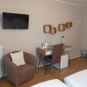 TV a/nebo společenská místnost v ubytování Hotel Les Alpes