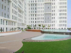 a rendering of a building with a swimming pool in front at Cozy Stay and Tranquil Studio Patraland Urbano Apartment By Travelio in Bekasi