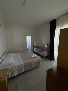 Postel nebo postele na pokoji v ubytování Hotel Bianca Orchidea
