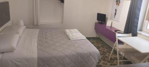 una camera con letto, TV e lavandino di Studio Bandiera apartment a Palermo