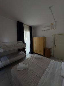 Postel nebo postele na pokoji v ubytování Hotel Bianca Orchidea