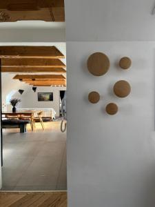 a room with a white wall with wooden circles on it at Steyr Old Town Loft - A charming 3 Bedroom Oasis in Steyr