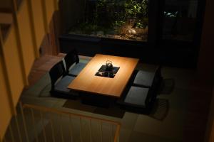 a table and chairs in a room with a window at NEW2025! Shirakaba ROKUI 白樺 緑居 Architect-designed Luxury Villa with Concierge Service in Osaka