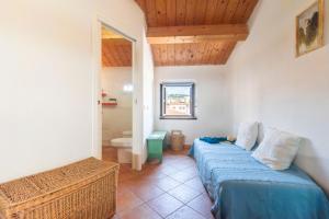 a bedroom with a bed and a bathroom at Una Mansarda Nell'isola - Happy Rentals in La Maddalena
