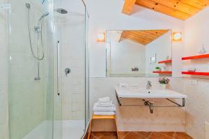 a bathroom with a sink and a shower at Una Mansarda Nell'isola - Happy Rentals in La Maddalena