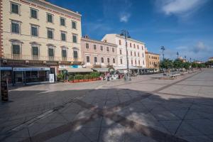 an empty street in a city with buildings at Una Mansarda Nell'isola - Happy Rentals in La Maddalena