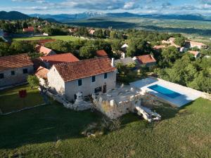 an aerial view of a house with a swimming pool at Holiday Home Leptir in Drniš