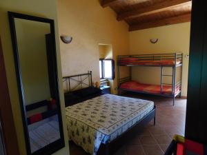 a bedroom with two bunk beds and a mirror at Villa Filìa - La Villa dell'Amicizia in Roccamorice +42 photos