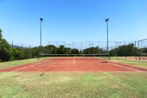 a tennis court with a net on top of it at Casa Vacanze Vista Mare-Piscina - PORTO ROTONDO in Porto Rotondo +34 photos