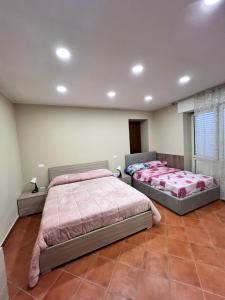 Postel nebo postele na pokoji v ubytování Appartamenti Minturnae Relais